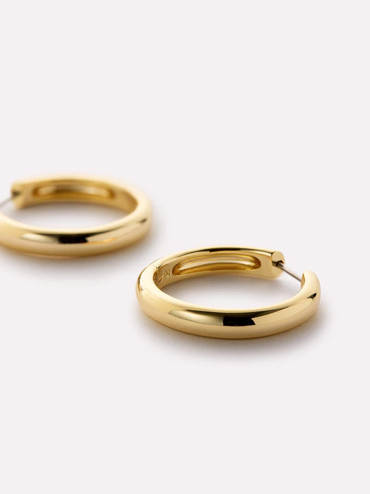 Totally timeless, these gold hoop earrings are plated in 14k gold and feature a chunky silhouette that’s perfect for styling solo or adding to any stack.