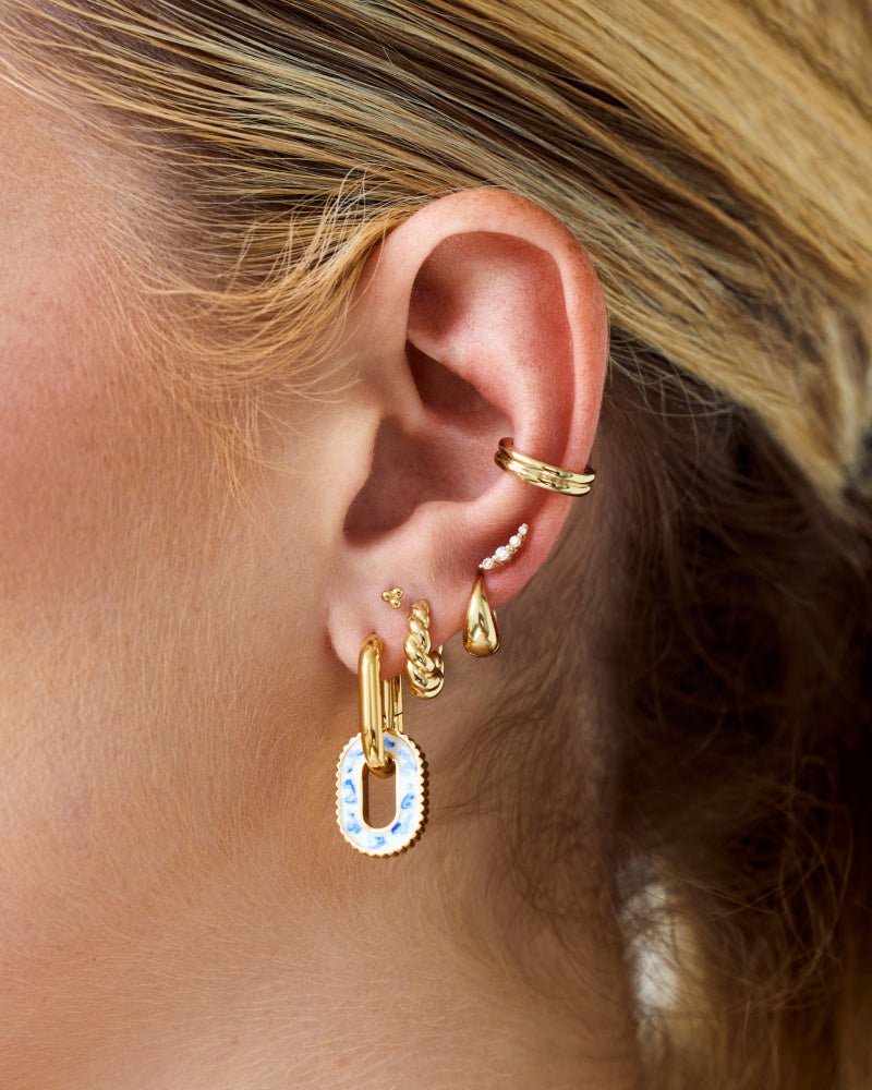 So cool and one-of-a-kind, these double hoop earrings dipped in 14k gold feature marble blue enamel detailing for a fun finishing touch to every look.