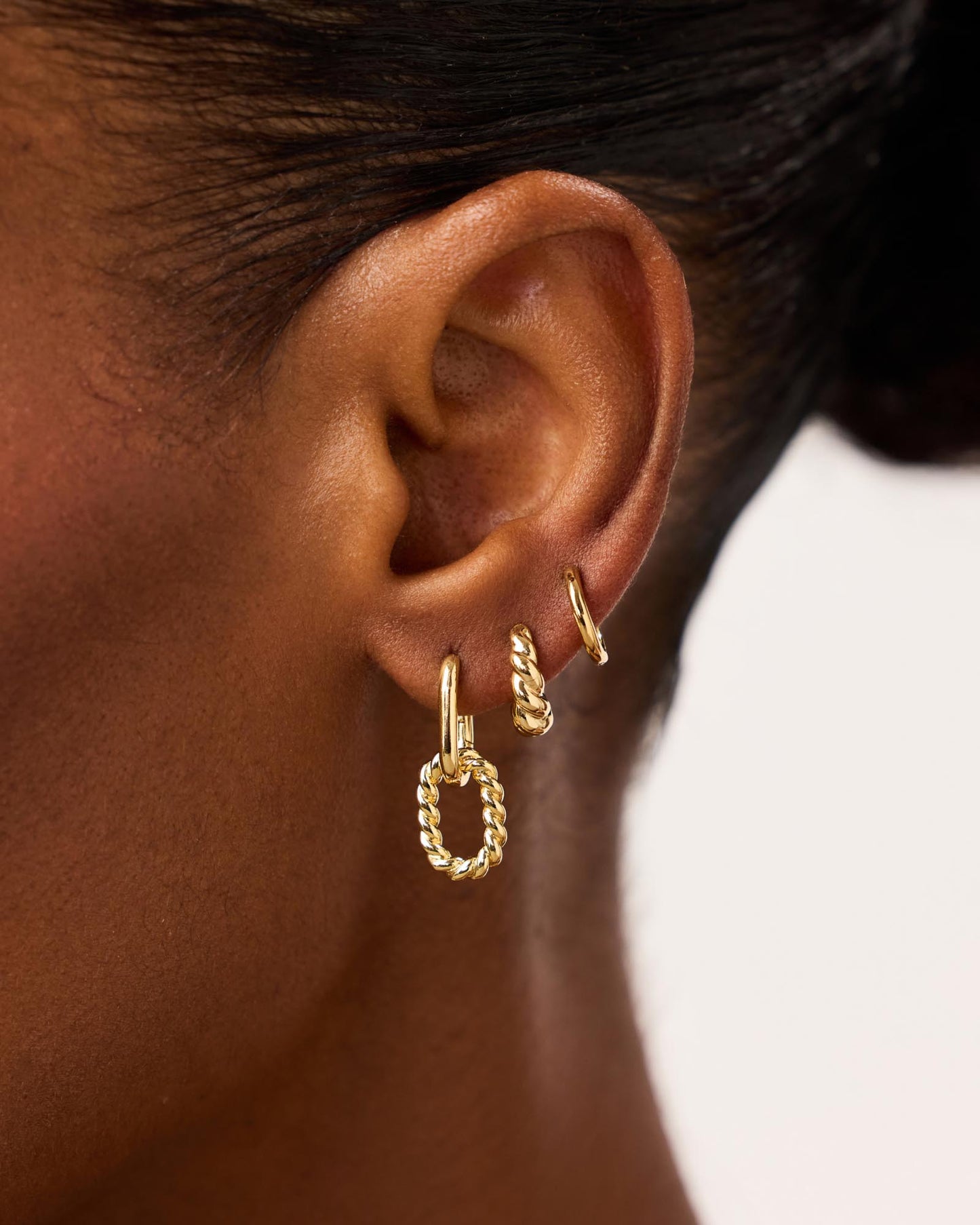 Minimal yet bold, these gold drop earrings plated in 14k gold feature two different textured hoops for a unique and elevated finishing touch to your stack.