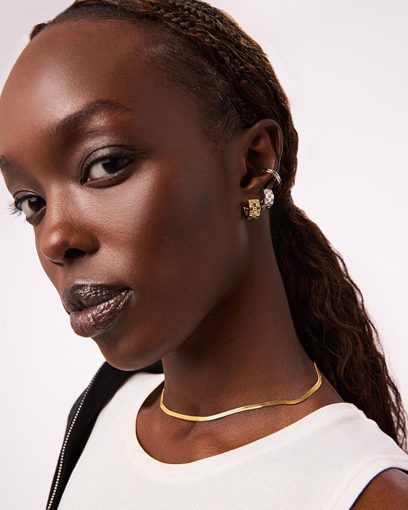 Sparkly and chic, these silver hoop earrings plated in rhodium feature a unique squared-off inlay and cubic zirconia embellishments for an eye-catching touch.
