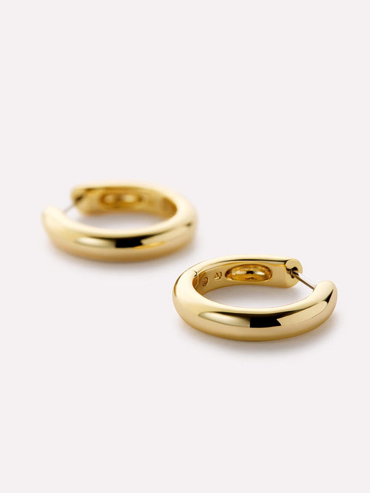 Chunky yet chic, these gold hoop earrings plated in 14k gold feature a shiny polished finish that adds an effortlessly elevated touch to any earring stack.
