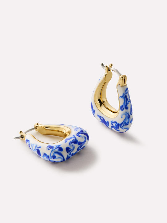 Destined to stand out, these statement earrings plated in 14k gold feature a handcrafted marble blue design making them a unique touch to every ear stack.