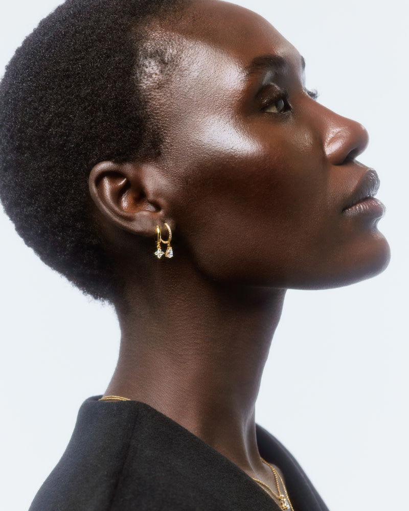 A perfect blend between huggie and teardrop designs, these delicate huggie hoops with sparkling cubic zirconia gems add a hint of subtle elegance to your look.