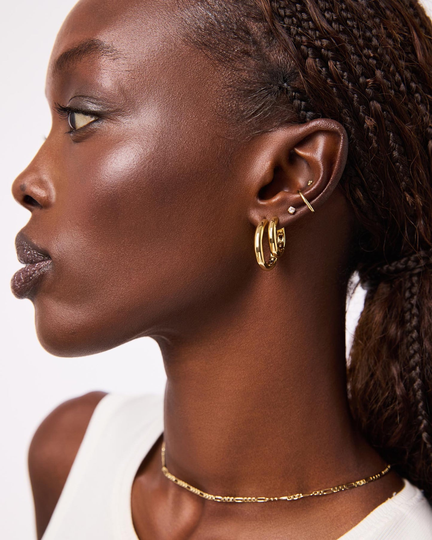 Totally timeless, these gold hoop earrings are plated in 14k gold and feature a chunky silhouette that’s perfect for styling solo or adding to any stack.