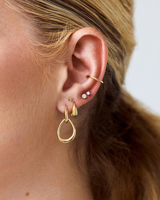 Our gold stud earrings designed to be worn alone or with your everyday earring stack, featuring an “invisible” bezel setting and shiny cubic zirconia stone.