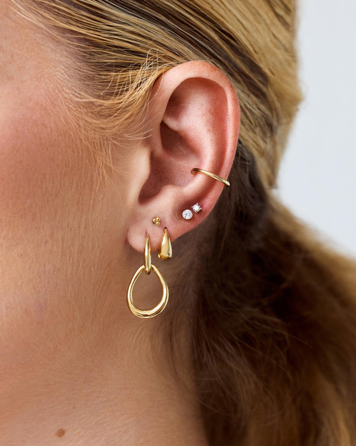 Business in the front, party on the sides—meet our bold huggie hoops.